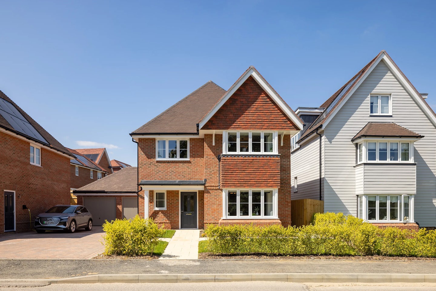 Detached British home with a smart tiled roof and driveway